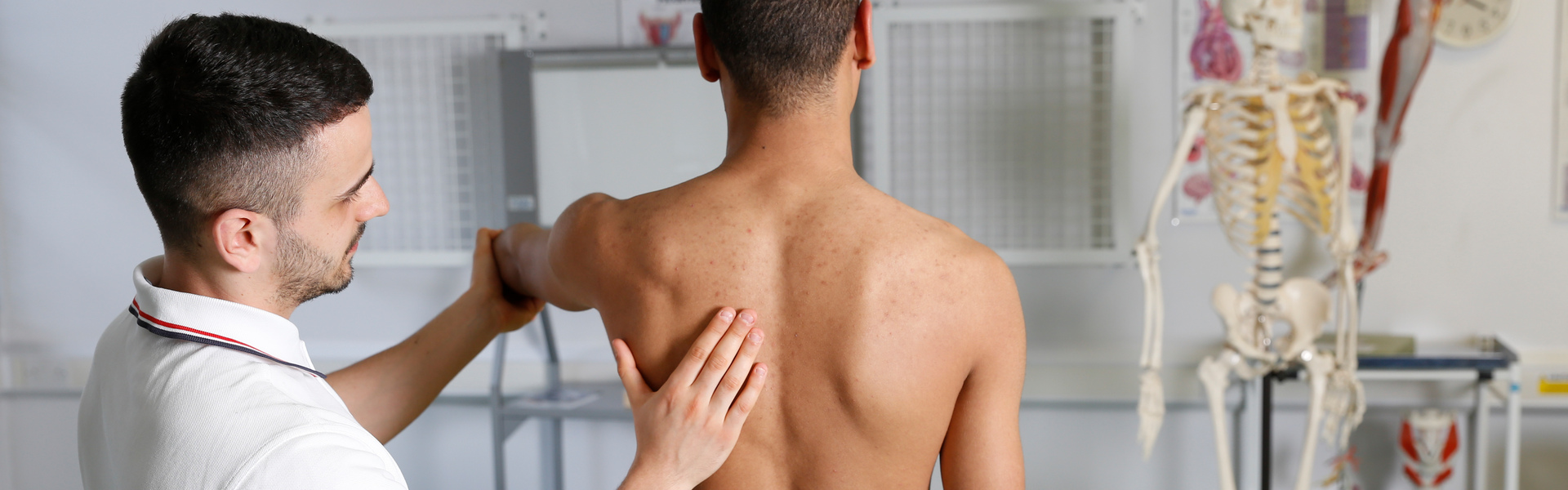 Physiotherapy student manipulating a patients shoulder
